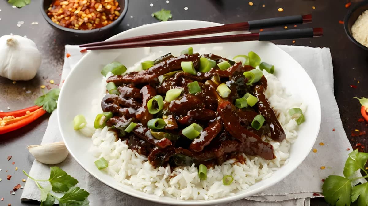 Mongolian beef over rice served on a plate