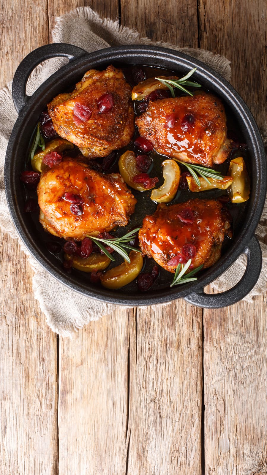 Cooked chicken thighs in a pan.