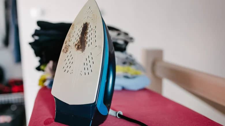 Dirty iron on ironing board