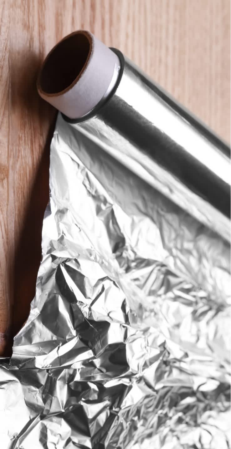 Roll of aluminum foil on table