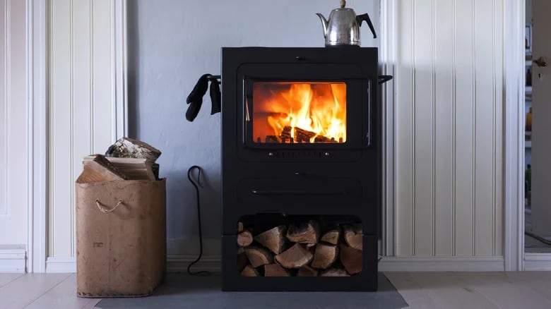 Close-up of black woodburning stove with fire burning inside