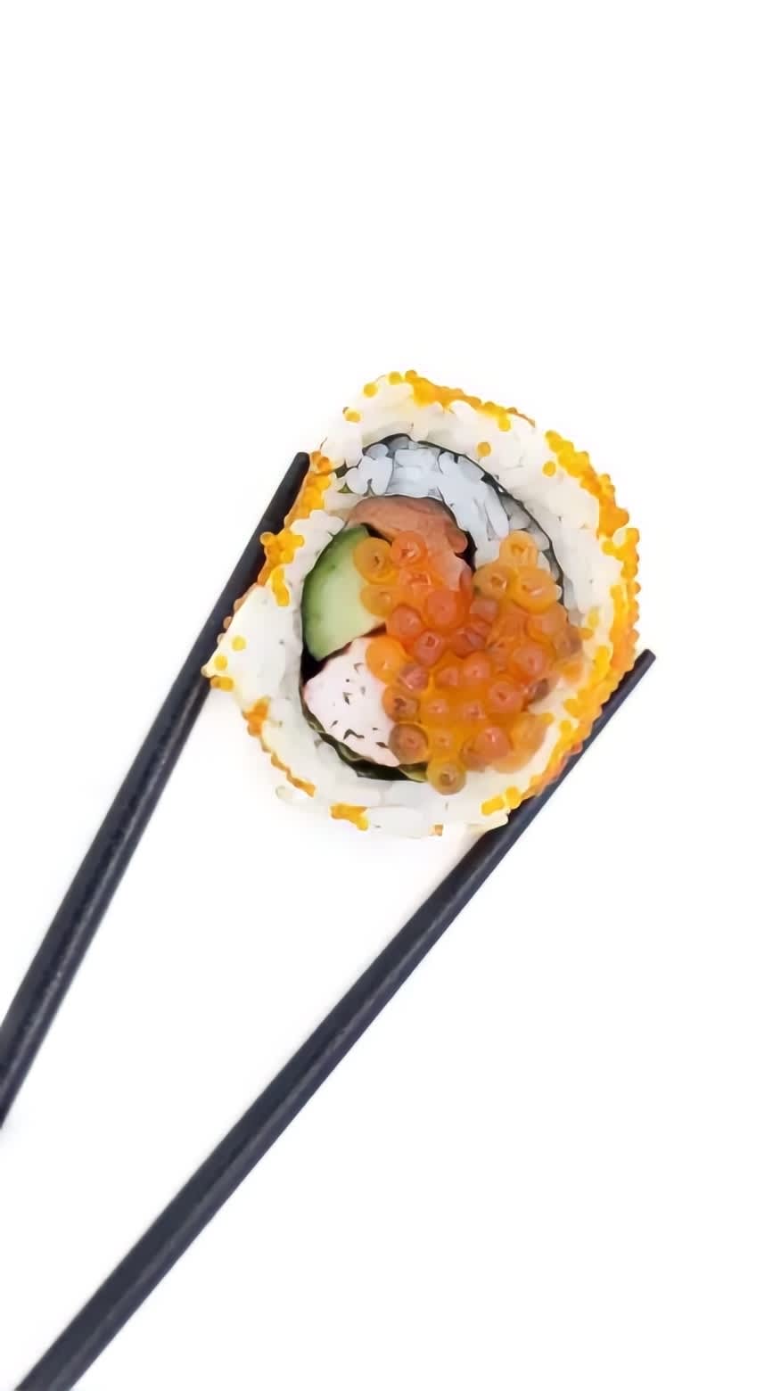 Tobiko on a sushi roll held in chopsticks