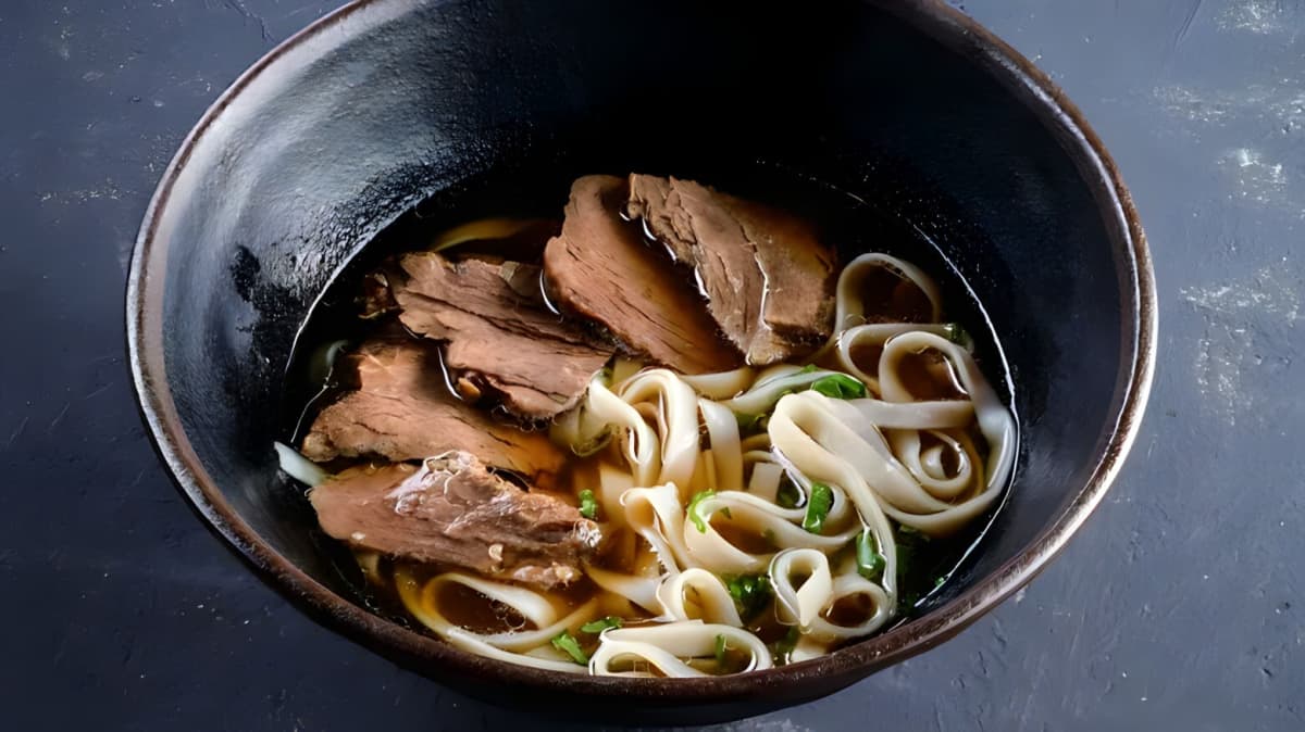 A bowl of pho with sliced beef