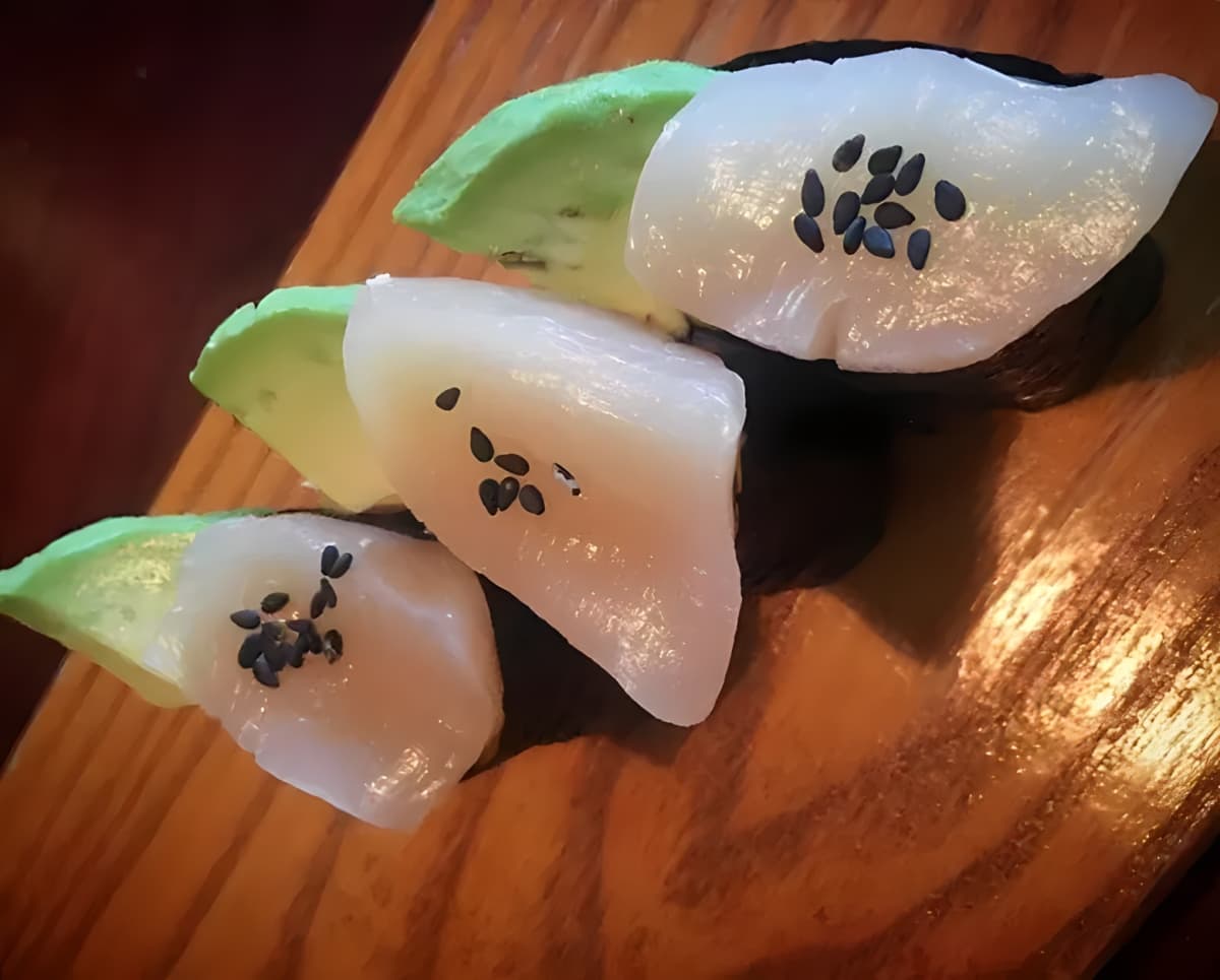 Escolar sushi sprinkled with black sesame seeds