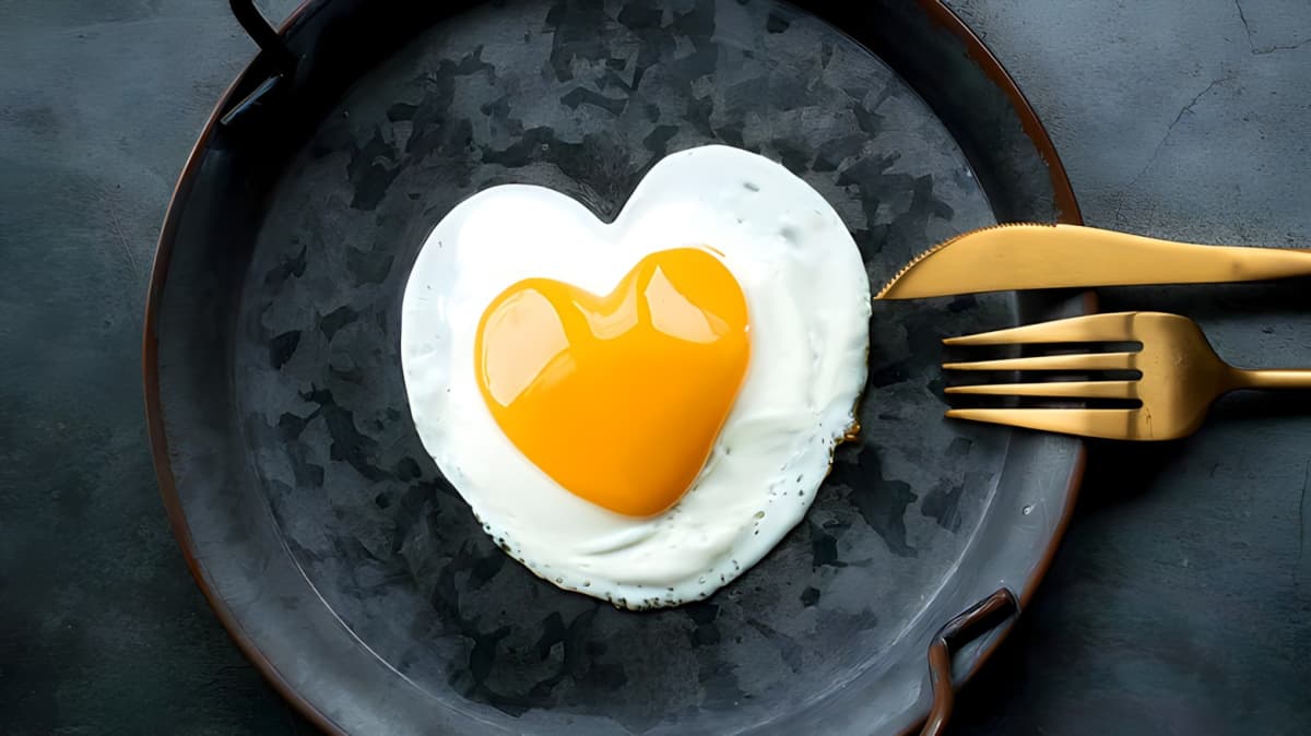 A fried egg in the shape of a heart